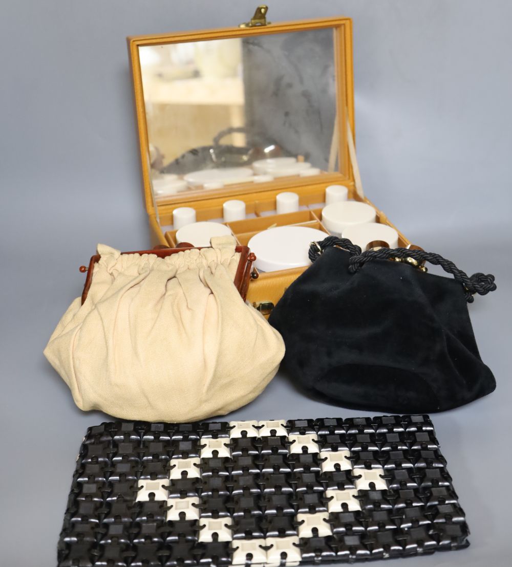 A 1960s plastic black and cream clutch bag, a black velvet bag and cream bag with Bakelite frame and a leather travel case